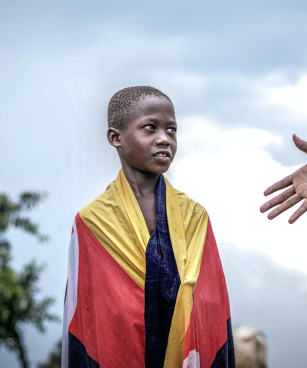 african-boy-looking-at-a-raised-hand.jpg